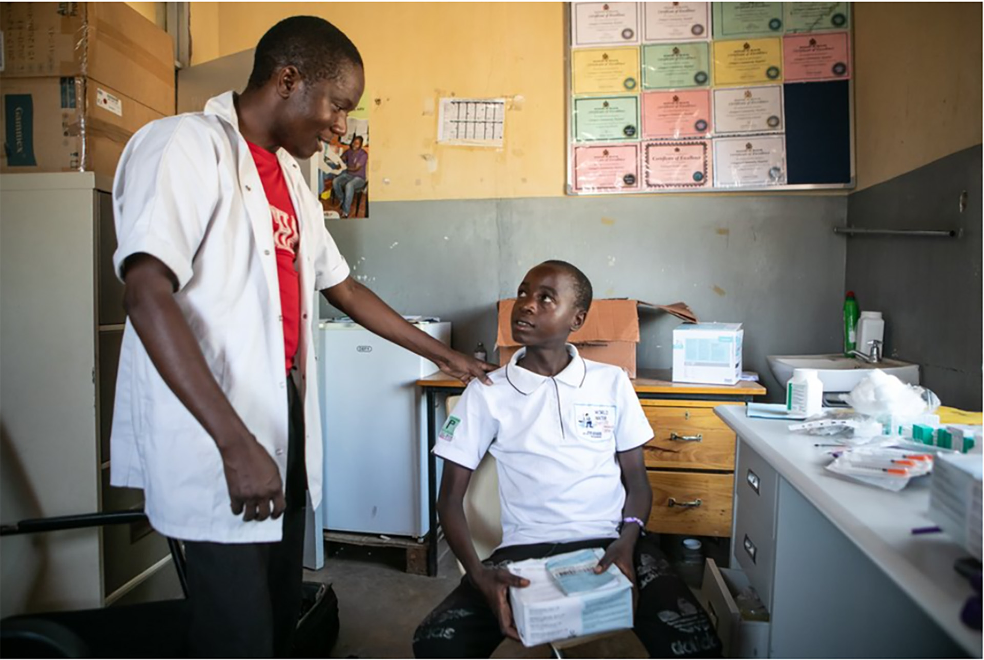 The health worker talking to a child in a clinic